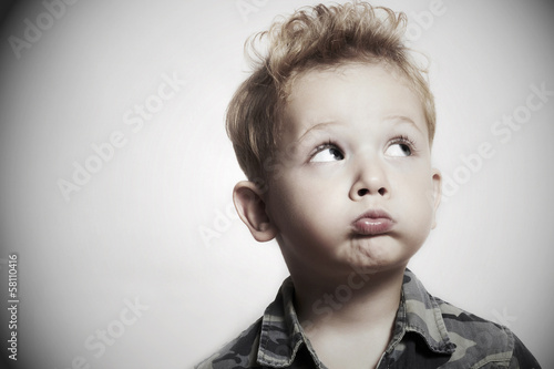 Photo: Child. funny little boy. 4 years old. military shirt Child. funny little boy. 4 years old. military shirt