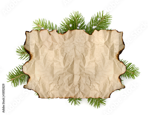 Photo: Old parchment paper with copy space on Christmas tree branch bac Old parchment paper with copy space on Christmas tree branch bac