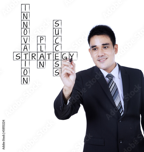 Photo: Businessman writing on transparent whiteboard Businessman writing on transparent whiteboard