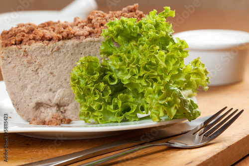 Photo: Venison pate on a plate decorated with salad. Venison pate on a plate decorated with salad.