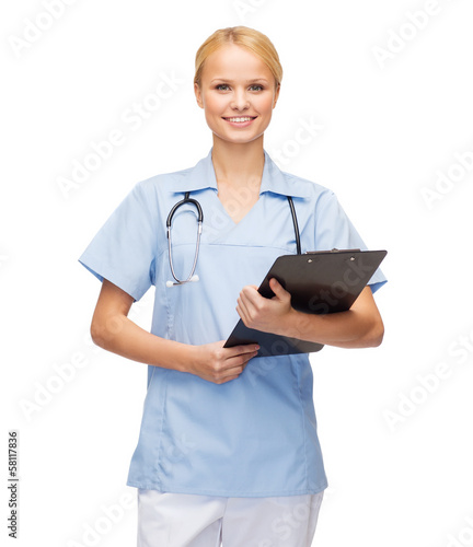 Photo: smiling female doctor or nurse with clipboard smiling female doctor or nurse with clipboard