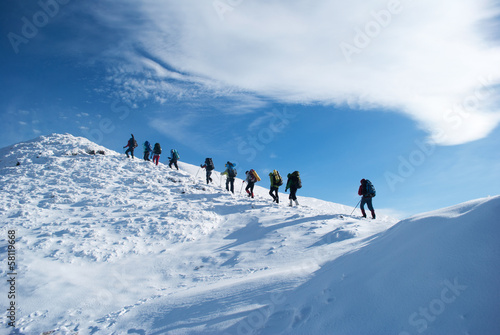 Photo: hikers in a winter mountain hikers in a winter mountain