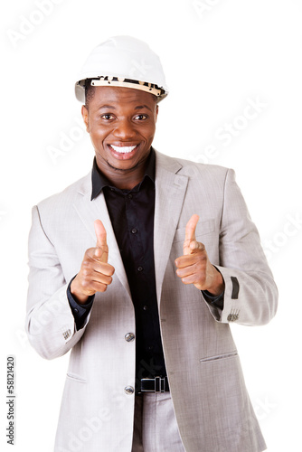 Photo: Male businessman wearing a helmet. Pointing. Male businessman wearing a helmet. Pointing.