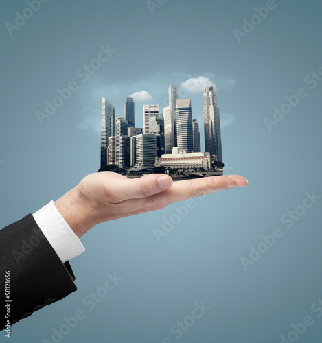Photo: hand holding building hand holding building
