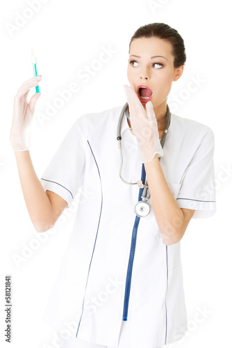 Photo: Attractive young nurse with syringe. Attractive young nurse with syringe.