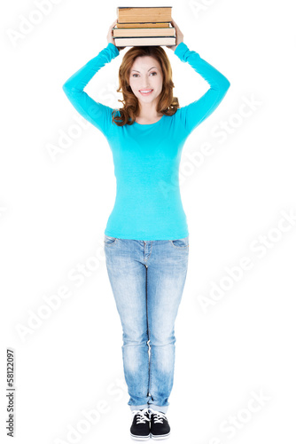 Photo: Student woman holding books on her head. Student woman holding books on her head.
