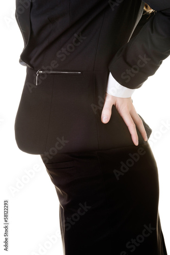 Photo: Business woman holding her back in a pain. Business woman holding her back in a pain.