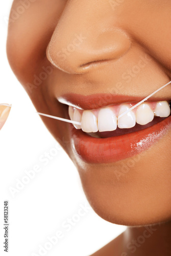 Photo: Attractive woman with dental floss. Closeup. Attractive woman with dental floss. Closeup.