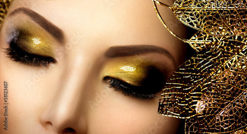 Photo: Fashion Glamour Makeup. Holiday Gold Glittering Eyeshadows Fashion Glamour Makeup. Holiday Gold Glittering Eyeshadows