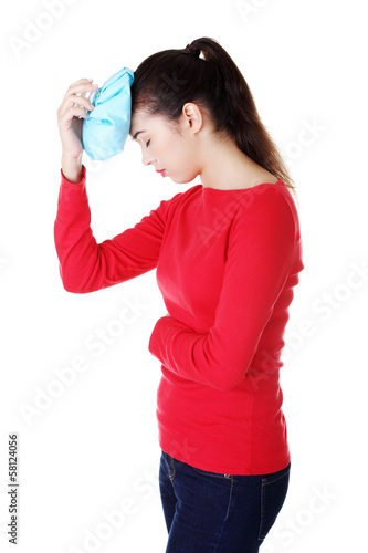 Photo: Casual young woman has headache. Casual young woman has headache.