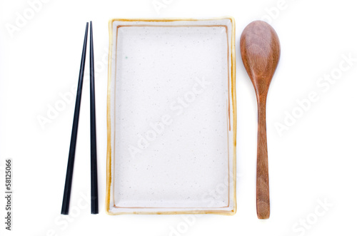 Photo: Ceramic Plate and chopsticks with wooden spoon ready for Asian f Ceramic Plate and chopsticks with wooden spoon ready for Asian f