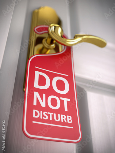 Illustration: Do not disturb sign on hotel door handle Do not disturb sign on hotel door handle