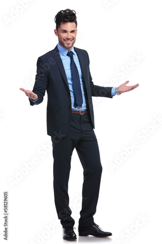 Photo: full body picture of a young business man welcoming full body picture of a young business man welcoming