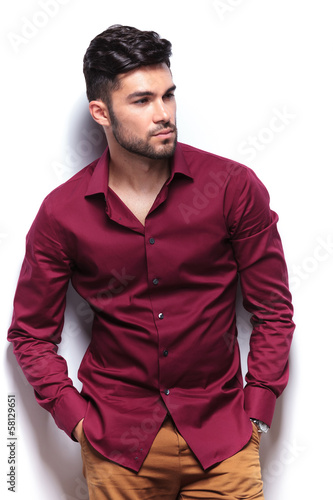 Photo: casual man looks away with hands in pockets casual man looks away with hands in pockets