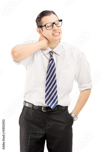 Photo: Young man suffering from a neck pain Young man suffering from a neck pain
