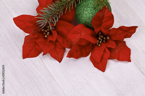 Photo: Christmas decoration.Poinsettia on a light background Christmas decoration.Poinsettia on a light background