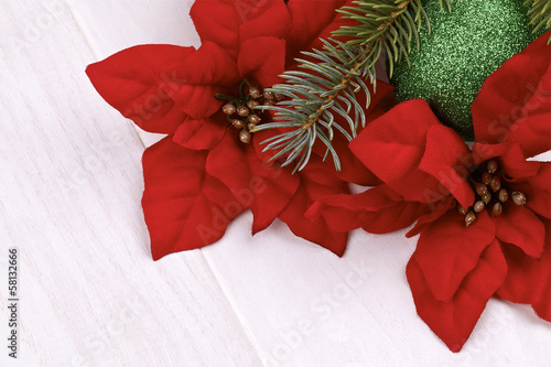Photo: Christmas decoration.Poinsettia on a light background Christmas decoration.Poinsettia on a light background
