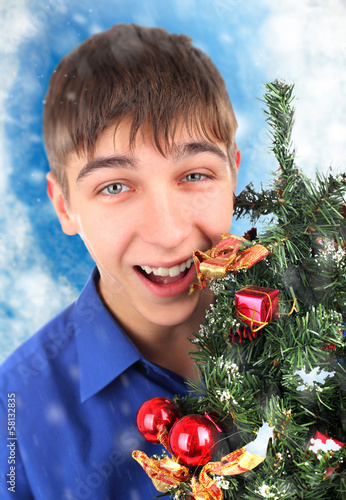 Photo: Happy Teenager with Christmas Tree Happy Teenager with Christmas Tree