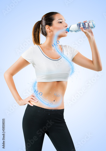 Photo: Fit young woman drinking water Fit young woman drinking water