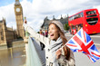 London - happy tourist holding UK flag by Big Ben London - happy tourist holding UK flag by Big Ben