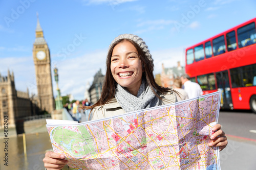 Photo: London tourist woman sightseeing holding map London tourist woman sightseeing holding map