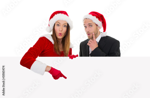 Photo: weihnachtspärchen zeigt auf tafel weihnachtspärchen zeigt auf tafel
