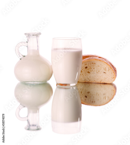 Photo: Glass and jug with milk on white background Glass and jug with milk on white background