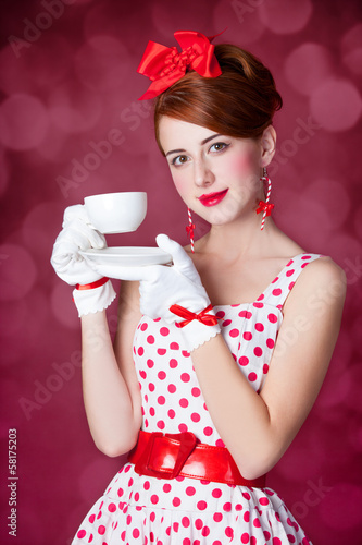 Photo: Beautiful redhead women with cup of tea. Beautiful redhead women with cup of tea.