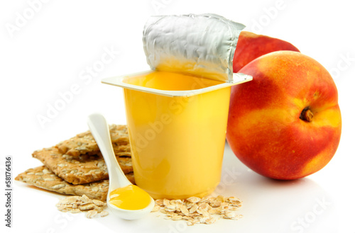Photo: Tasty yogurt in open plastic cup, cookies and fruit, isolated Tasty yogurt in open plastic cup, cookies and fruit, isolated