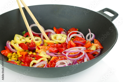 Photo: Vegetables in wok isolated on white Vegetables in wok isolated on white