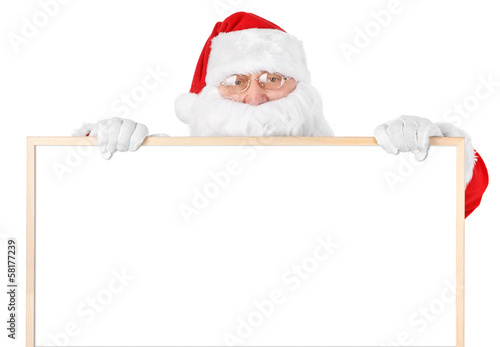 Photo: Santa and empty white board over white Santa and empty white board over white