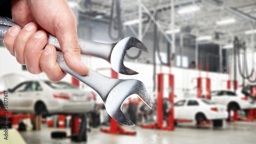 Photo: Hand with wrench. Auto mechanic. Hand with wrench. Auto mechanic.