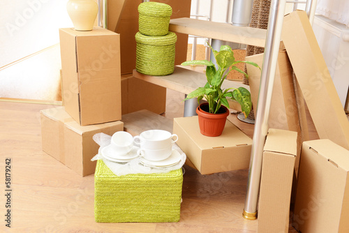 Photo: Stack of cartons near stairs: moving house concept Stack of cartons near stairs: moving house concept