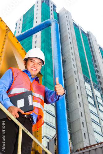 Photo: Asian worker or supervisor on building site Asian worker or supervisor on building site