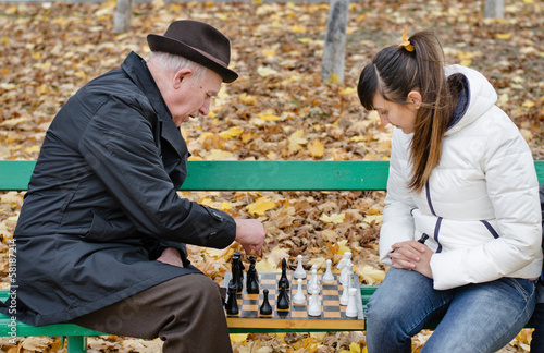 Photo: Senior man spending quality time playing chess Senior man spending quality time playing chess