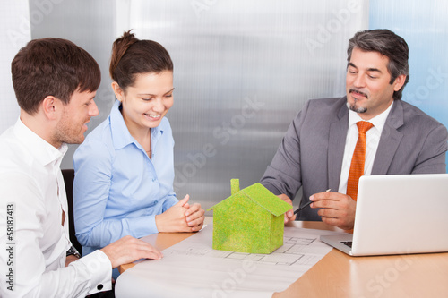 Photo: Couple And Consultant Discussing Together Couple And Consultant Discussing Together