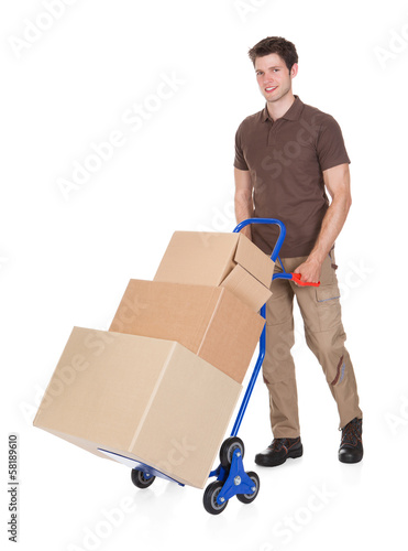 Photo: Delivery Man With Hand Truck And Boxes Delivery Man With Hand Truck And Boxes