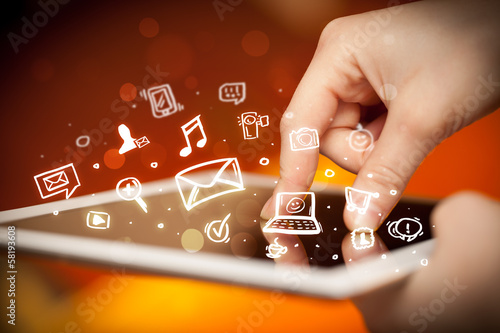 Photo: Finger pointing on tablet pc, social media concept Finger pointing on tablet pc, social media concept