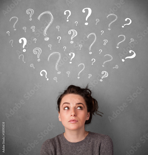 Photo: Young woman with question marks above her head Young woman with question marks above her head