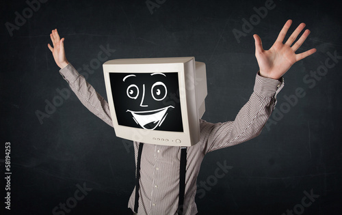 Photo: Happy businessman with a PC monitor head and a smiley face Happy businessman with a PC monitor head and a smiley face