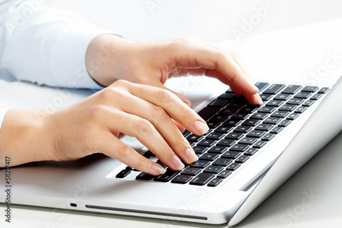 Photo: Hands with laptop computer keyboard. Hands with laptop computer keyboard.