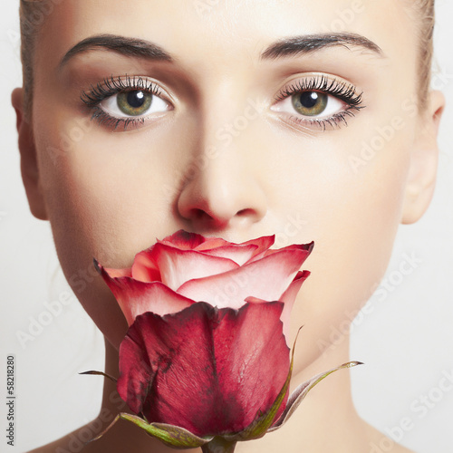 Photo: beautiful blond woman with flower.girl and rose beautiful blond woman with flower.girl and rose