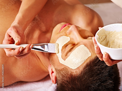 Photo: Clay facial mask in beauty spa. Clay facial mask in beauty spa.
