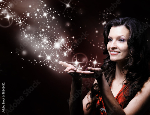Photo: beautiful girl blowing magic stars beautiful girl blowing magic stars