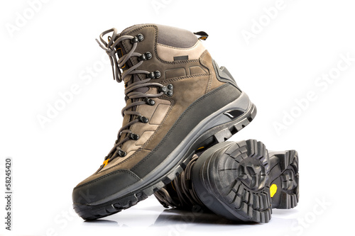Photo: A pair of new hiking boots on white background A pair of new hiking boots on white background