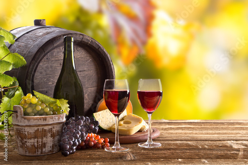 Photo: Wine bottle and glasses on wooden table Wine bottle and glasses on wooden table