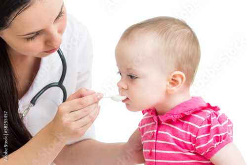 Photo: doctor giving remedy to baby girl doctor giving remedy to baby girl