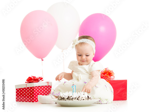 Photo: baby girl touching birthday cake baby girl touching birthday cake