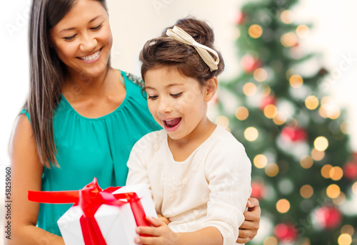 Photo: happy mother and child girl with gift box happy mother and child girl with gift box