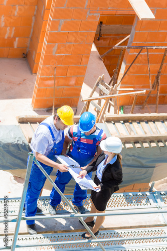 Photo: Team discussing construction or building site plans Team discussing construction or building site plans